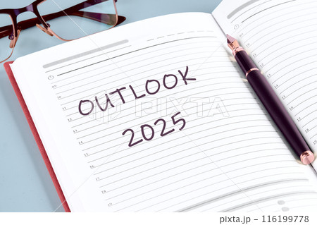 Economic outlook concept. Financial, business review or economic growth forecast for 2025. OUTLOOK 2025 in the notebook of a businessman, manager Economic outlook concept. Financial, business review or economic growth forecast for 2025. OUTLOOK 2025 in the notebook of a businessman, manager 116199778