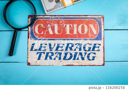 Leverage Trading. Caution sign with text on wooden texture table 116200258