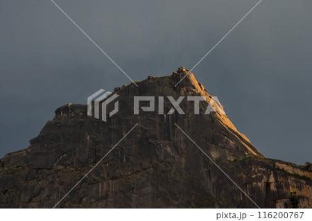 Big mountain top in orange light. 116200767