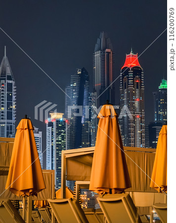 Folded umbrellas of the hotel at night. Dubai. 116200769