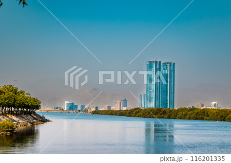embankment of the city of Donetsk along the Kalmius river. Multi-storey buildings rise. A bridge crosses the river connecting part of the city. High quality photo 116201335