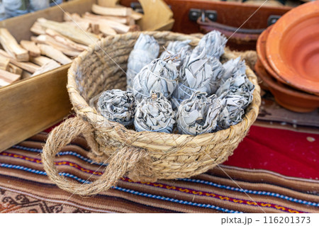 White sage also known as Salvia apiana, smudge sticks, herbal bundles in wicker basket, ceremonial use 116201373