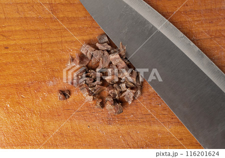 Finely chopped anchovy fillet, marinated fish, traditional salted anchovy in oil on wood 116201624