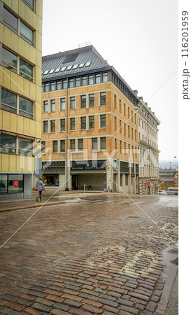 Orange brick building corner of Steinway Piano Gallery in Helsinki bottom up view from wet road Orange brick building corner of Steinway Piano Gallery in Helsinki bottom up view from wet road 116201959