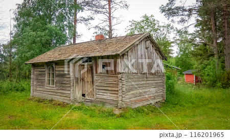 Ancient wooden hut surrounded by greenery in Finland Ancient wooden hut surrounded by greenery in Finland 116201965