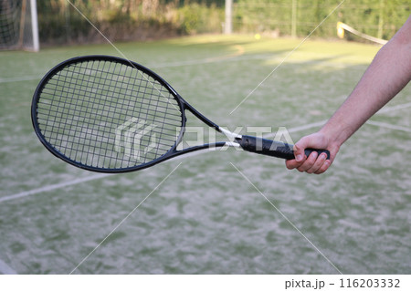The Hand Grip On The Racket Of A Tennis Player  116203332