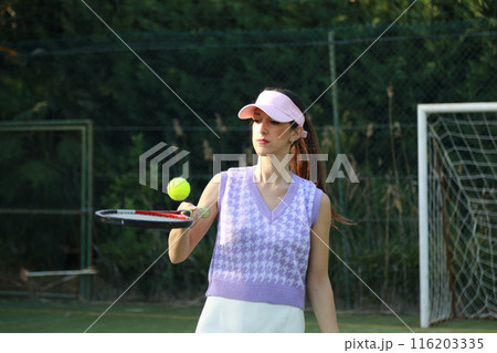 Woman Keeping The Ball In The Air With The Racket  116203335