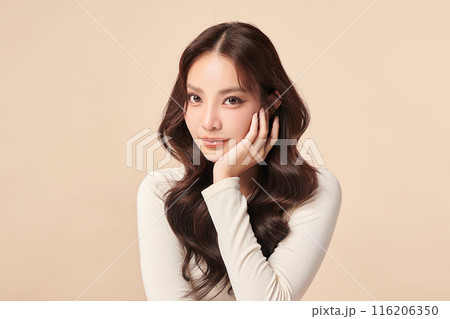 Beautiful young asian woman with clean fresh skin on beige background, Face care, Facial treatment, Cosmetology, beauty and spa, Asian women portrait. 116206350