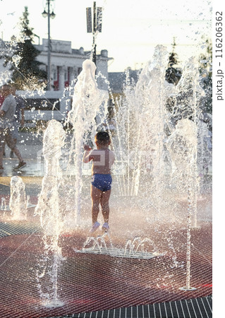 Summer in the city - children playing with fountain 116206362