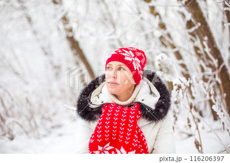 Portrait of happy young woman in winter forest Portrait of happy young woman in winter forest 116206397