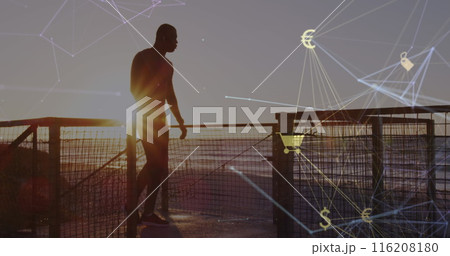 Image of connected icons globe over silhouette on man running up stairs at beach after jogging 116208180