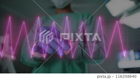 Image of heart rate monitor against mid section of male surgeon wearing surgical gloves Image of heart rate monitor against mid section of male surgeon wearing surgical gloves 116208640