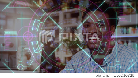 Image of data processing over smiling african american man in cafe 116210829