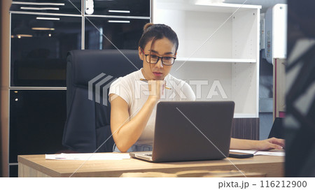 Businesswoman hands type on laptop writing on notebook meeting at office desk. Asian Woman Hands writing planning on office paper use calendar from laptop. Female hand holding pen work Business Plan 116212900