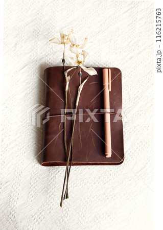 Notebook and drying flowers, autumn still life. 116215763