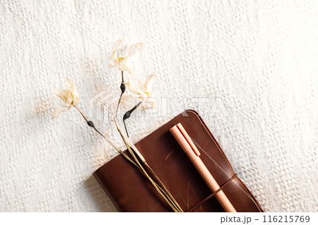 Notebook and drying flowers, autumn still life. Notebook and drying flowers, autumn still life. 116215769