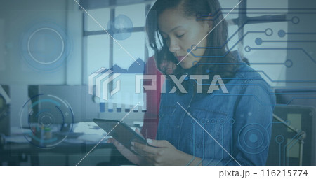 Image of graphs and circuit board patterns over caucasian businesswoman using digital tablet 116215774
