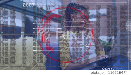 Image of data processing and spinning globe over african american woman using laptop at office 116216474