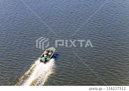Boat with fishermen at the river Dnieper, Ukraine 116217312
