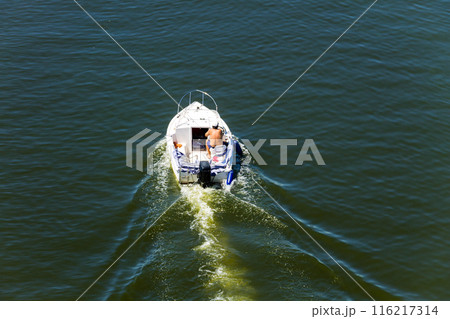 Motor boat floating on the river Dnieper 116217314