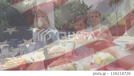 Image of american flag over happy caucasian family having dinner and talking Image of american flag over happy caucasian family having dinner and talking 116218726