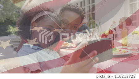 Image of american flag over family having dinner and taking selfie 116218728