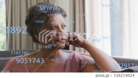 Image of numbers over senior african american woman Image of numbers over senior african american woman 116219024