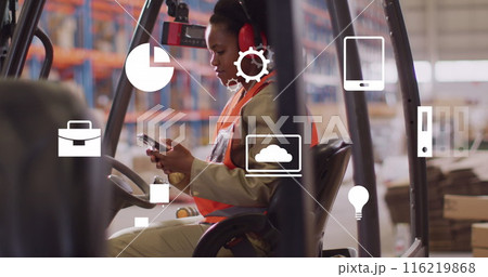 Image of media icons over african american female worker using smartphone in warehouse 116219868