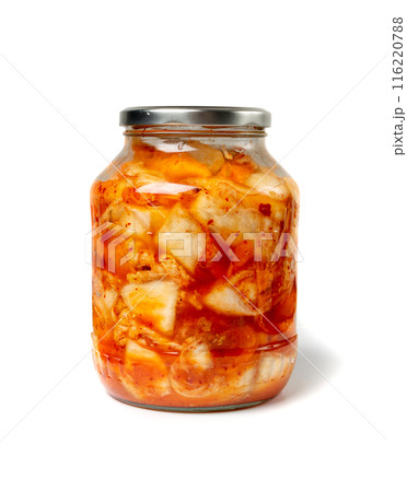 Kimchee in a glass jar isolated. Spicy kim chi, hot fermented napa cabbage, jimchi, korean gimchi Kimchee in a glass jar isolated. Spicy kim chi, hot fermented napa cabbage, jimchi, korean gimchi 116220788