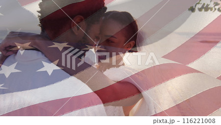 Image of american flag over smiling african american married couple at beach 116221008