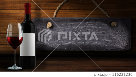 Image of lights over bottle and glass of red wine over wooden background with tag 116221230