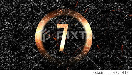 Large number seven glowing within circular frame against a dark, textured background 116221418