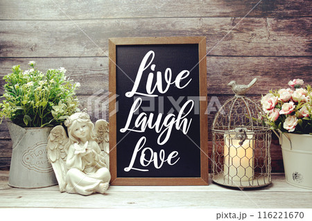 Inspirational quote Live Laugh Love text message written on chalkboard background Inspirational quote Live Laugh Love text message written on chalkboard background 116221670