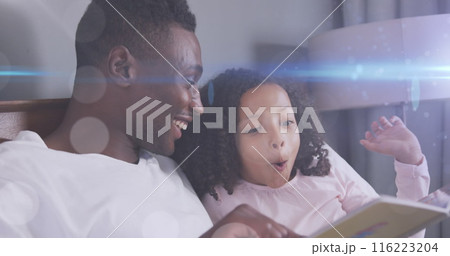 Image of light spots over happy african american father reading book with daughter 116223204