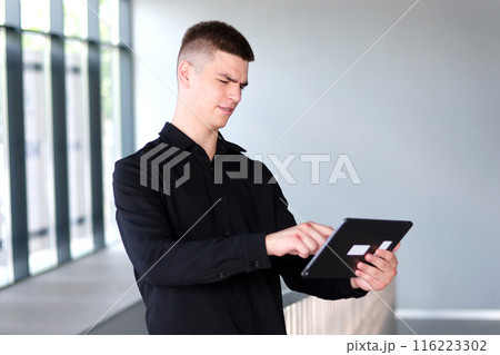 guy with broken hands holds a tablet in his hands after fight guy with broken hands holds a tablet in his hands after fight 116223302