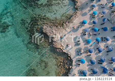 Aerial view of Nissi beach resort with blue umbrellas. Ayia Napa, Cyprus 116223514