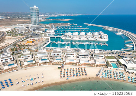 Aerial view of a modern Ayia Napa marina with tourists relaxing on the beach. Cyprus 116223568