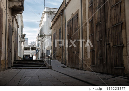 Empty narrow street with old buildings near Buffer Zone in Nicosia city, Cyprus 116223575