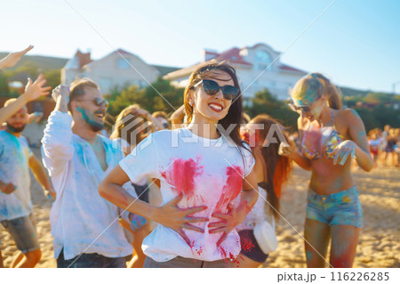 A group of friends have fun, dance at the holi festival. Celebrating traditional indian spring holiday. Friendship. A group of friends have fun, dance at the holi festival. Celebrating traditional indian spring holiday. Friendship. 116226285