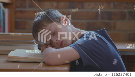 Image of looping changing numbers over caucasian boy sleeping on book in classroom 116227401
