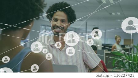 Image of network of connections with icons over diverse business people in office Image of network of connections with icons over diverse business people in office 116227423