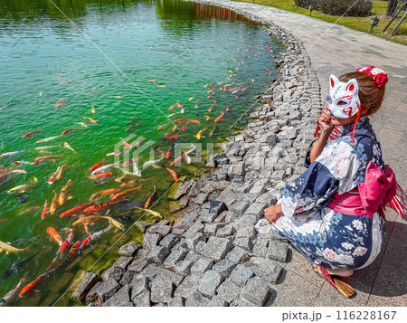 Asian girl in kimono and umbrella in Japanese theme park Hinoki Land in Chai Prakan District, Chiang 116228167