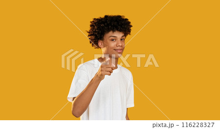You pointing. Encouraging gesture. Confident smiling guy supporting showing approval isolated on yellow empty space background. You pointing. Encouraging gesture. Confident smiling guy supporting showing approval isolated on yellow empty space background. 116228327