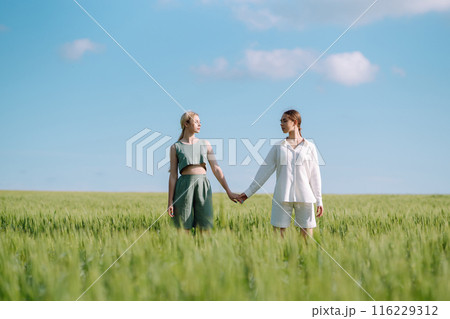 Two Beautiful woman in the green field. Nature, vacation, relax and lifestyle. Summer landscape. 116229312