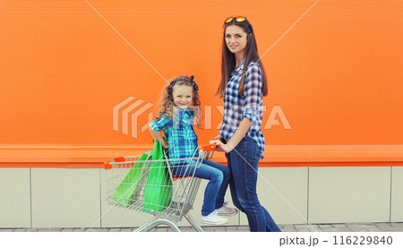 Happy young mother and little girl child, family shopping, stylish mom with kid daughter in the city Happy young mother and little girl child, family shopping, stylish mom with kid daughter in the city 116229840