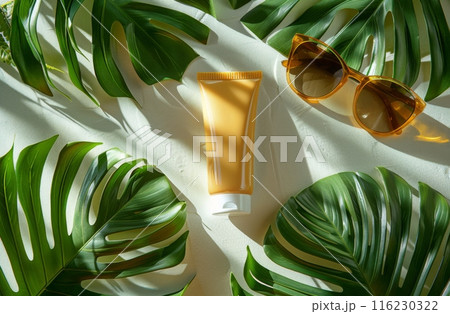 Sunscreen cream tube, sunglasses, and tropical palm leaves on a white background with shadows Sunscreen cream tube, sunglasses, and tropical palm leaves on a white background with shadows 116230322
