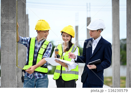 Team of structural engineers and businessman planning development details about project at construction site Team of structural engineers and businessman planning development details about project at construction site 116230579