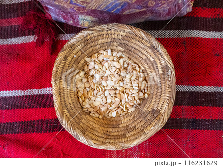 Argan seeds in a woven basket, part of traditional argan oil production, natural setting, textured surface Argan seeds in a woven basket, part of traditional argan oil production, natural setting, textured surface 116231629