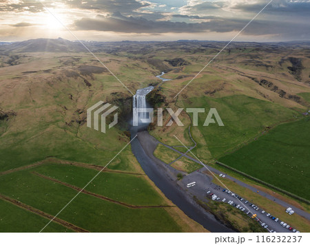 Impressively beautiful nature of Iceland during sunset. Skogafoss waterfall is one famous natural landmark and travel destination place of Iceland. Tourists ride horses near famouse waterfall. Impressively beautiful nature of Iceland during sunset. Skogafoss waterfall is one famous natural landmark and travel destination place of Iceland. Tourists ride horses near famouse waterfall. 116232237