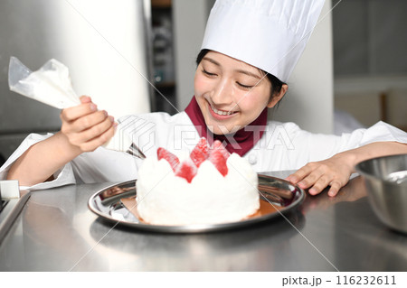 ホールケーキを製造するパティシエの女性 116232611